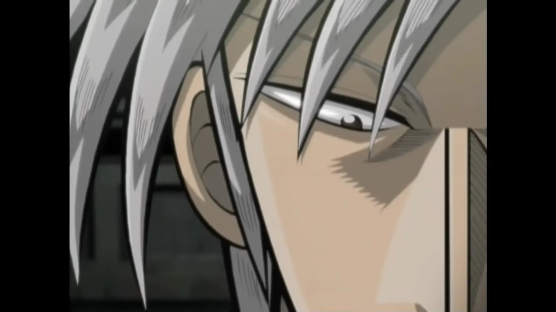 Close up view of Akagi staring down his opponent intimidatingly.
